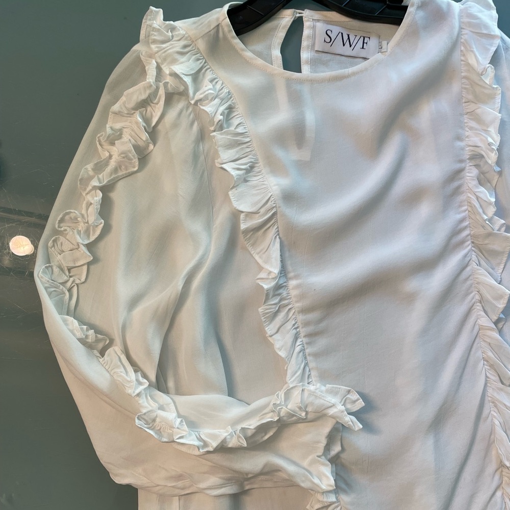 White ruffly top
